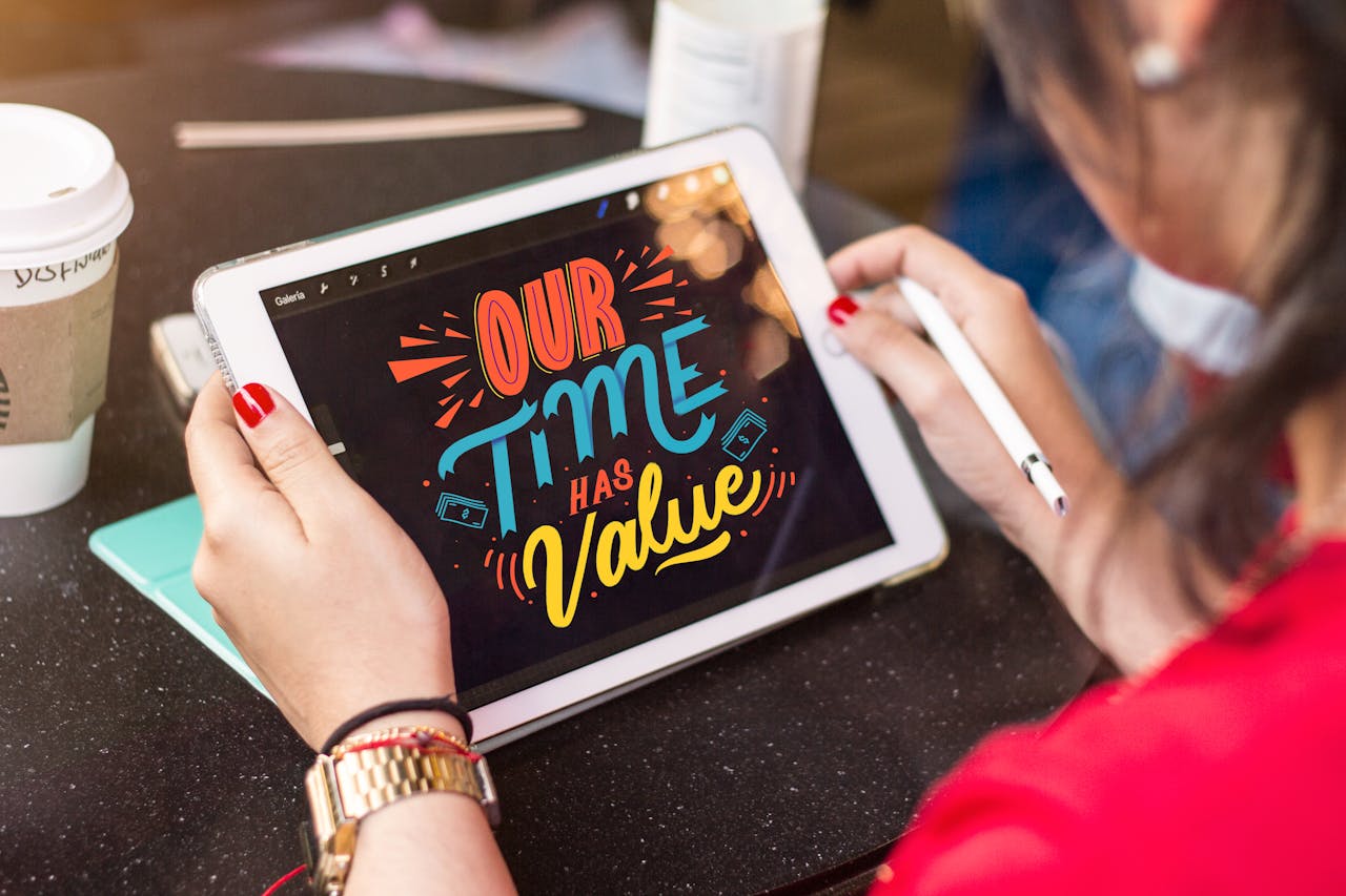 Woman using a tablet to create colorful digital art emphasizing time value.